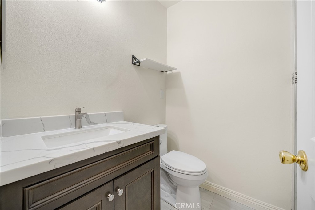 13223 3rd Street Chino, CA 91710 - Photo 5 of 15 a bathroom with a sink a toilet and a mirror