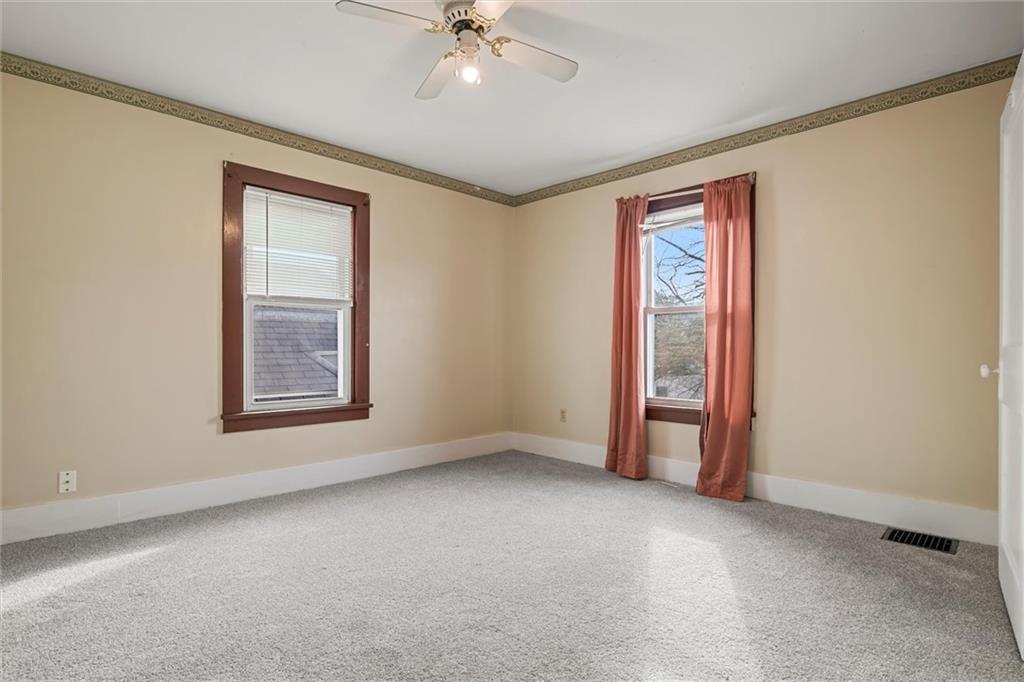 325 Walnut Street Vandergrift, PA 15690 - Photo 13 of 29 an empty room with windows and fan