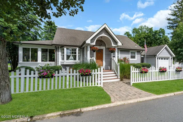 a front view of a house with a garden