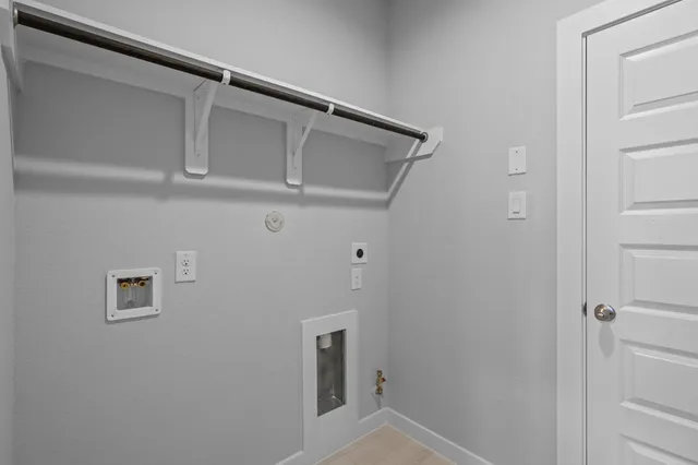 a view of an empty room with a kitchen