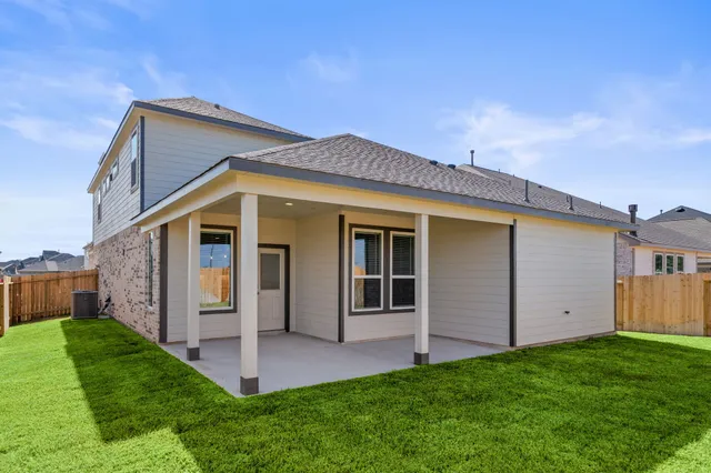 a front view of a house with a garden and plants