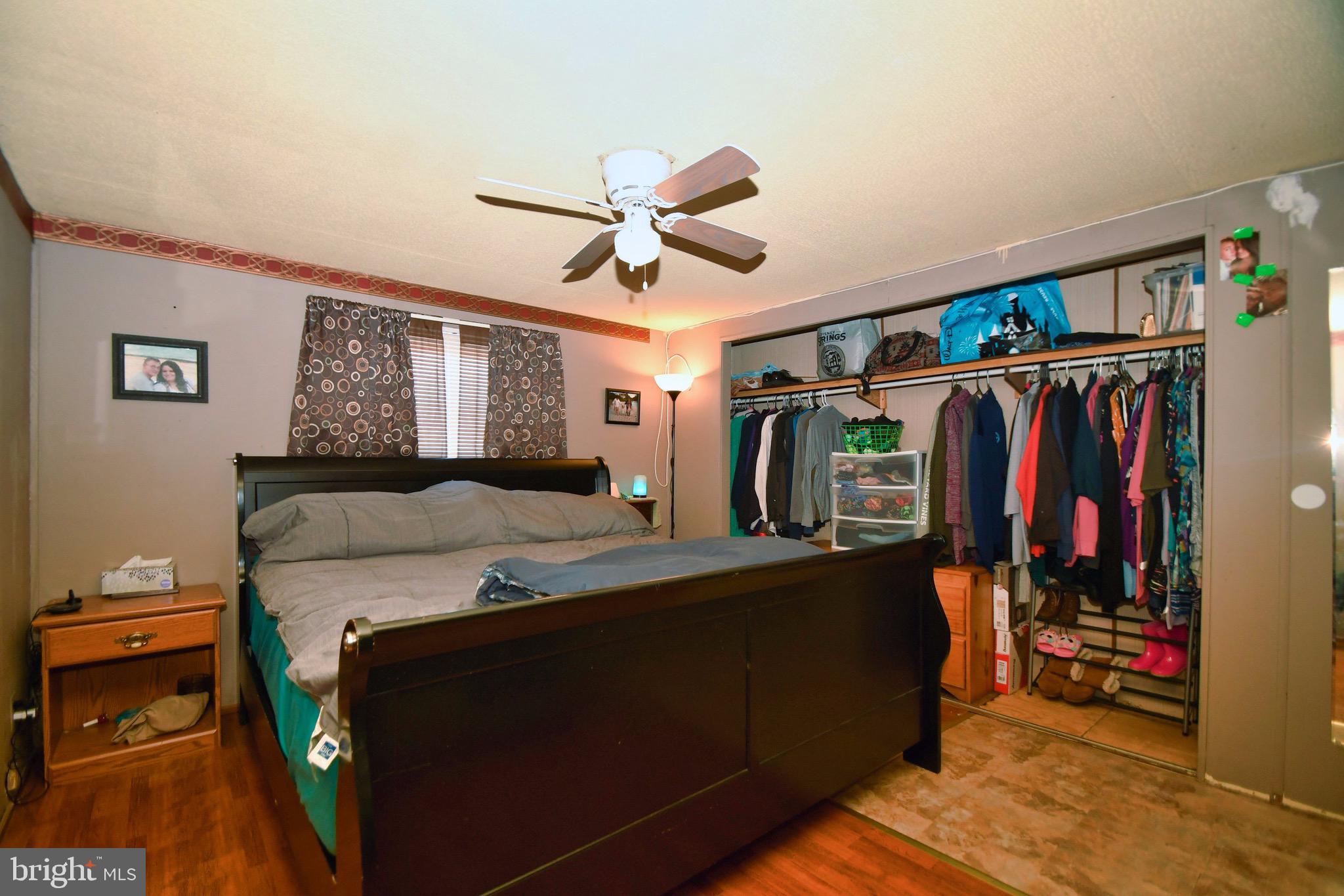 124 Lariat Road Middle River, MD 21220 - Photo 3 of 21 a bed room with a bed and a walk in closet