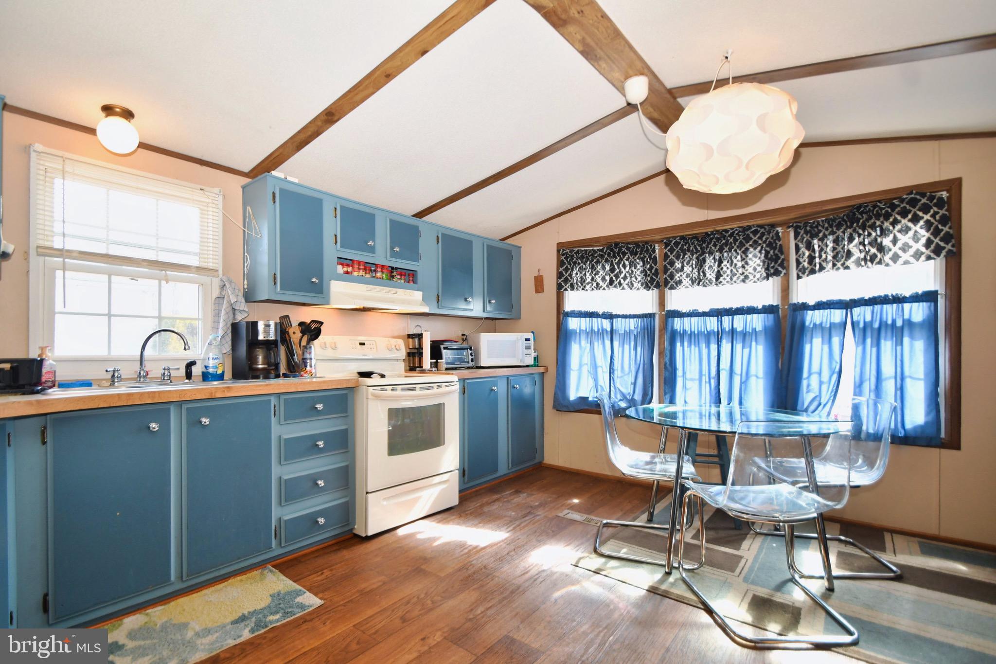 124 Lariat Road Middle River, MD 21220 - Photo 8 of 21 a kitchen with a dining table chairs stove and cabinets