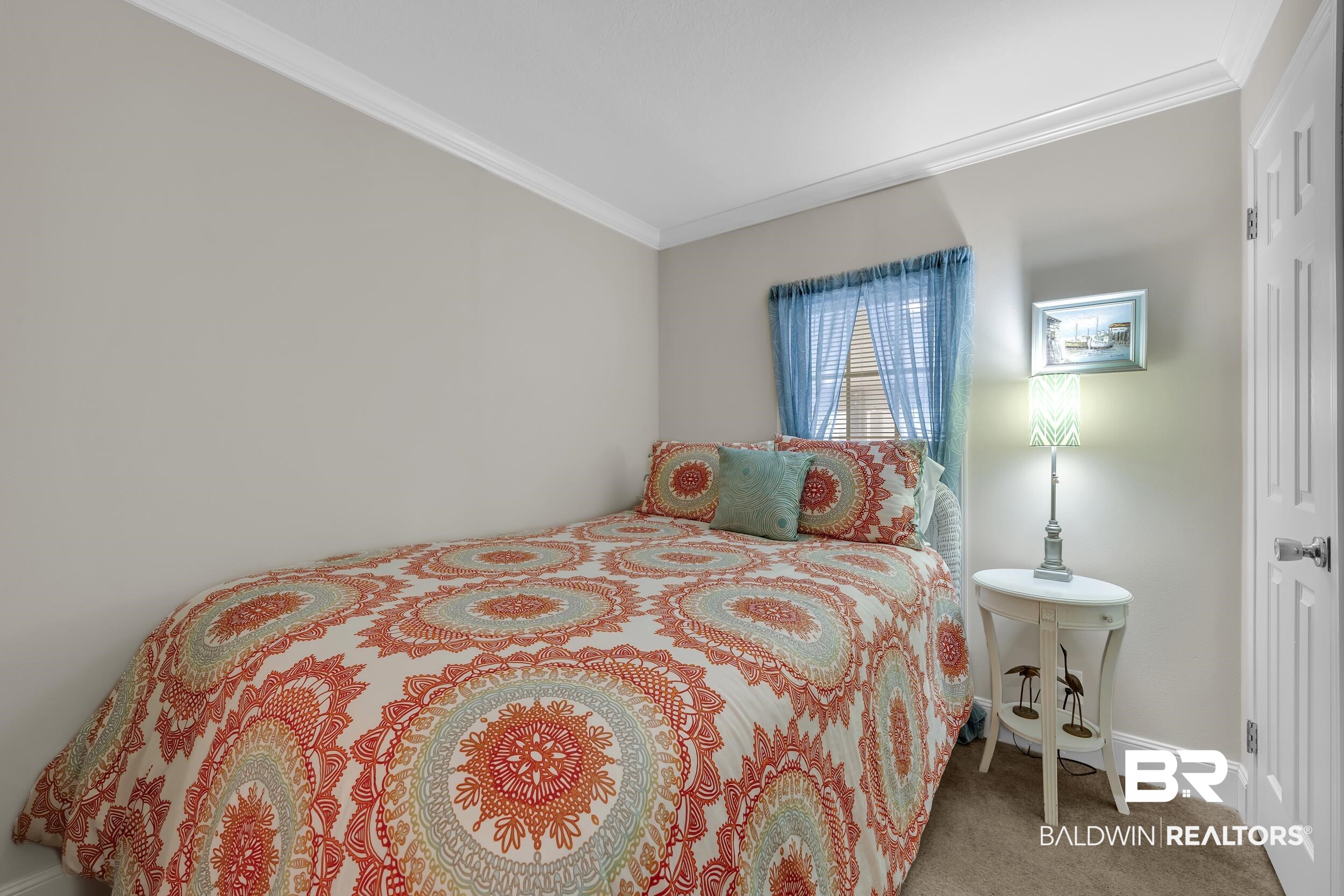 16707 Fort Morgan Road, Unit 8 Gulf Shores, AL 36542 - Photo 12 of 27 Bedroom featuring ornamental molding and carpet flooring