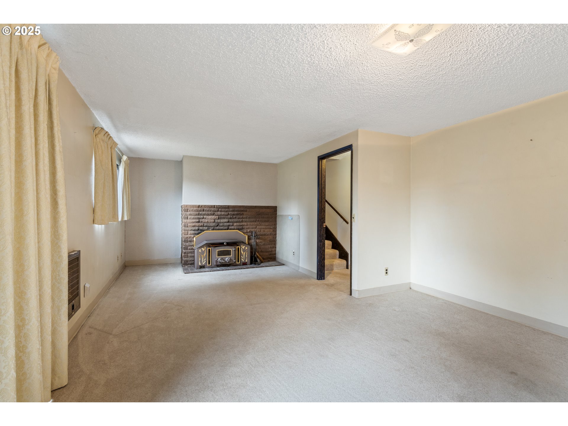 5673 Southwest Old Highway 47 Gaston, OR 97119 - Photo 19 of 33 a view of an empty room with a fireplace