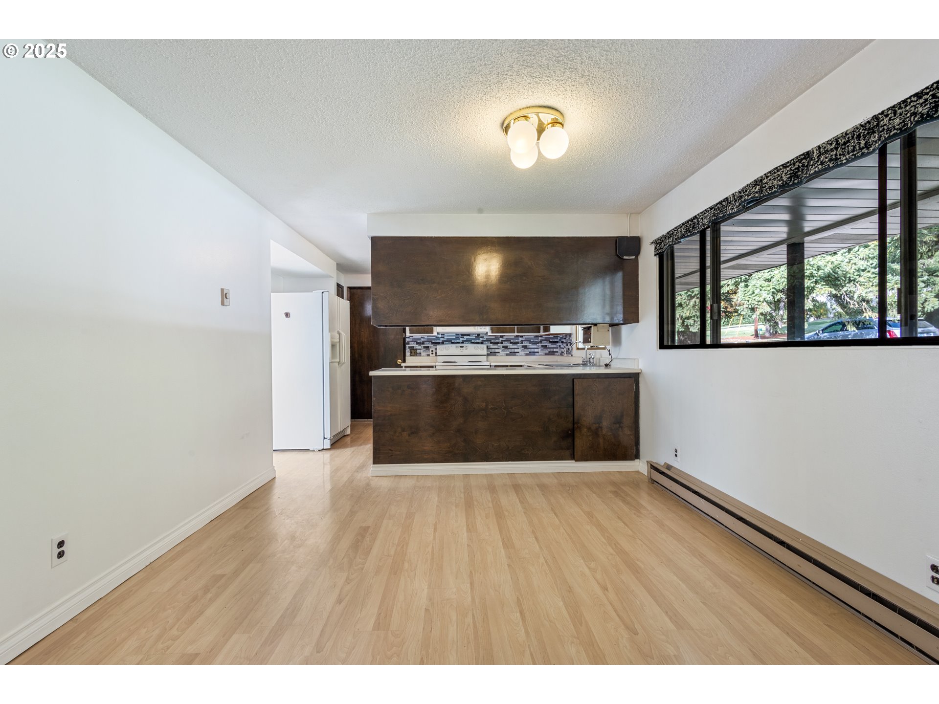 5673 Southwest Old Highway 47 Gaston, OR 97119 - Photo 29 of 33 a view of kitchen with window and wooden floor