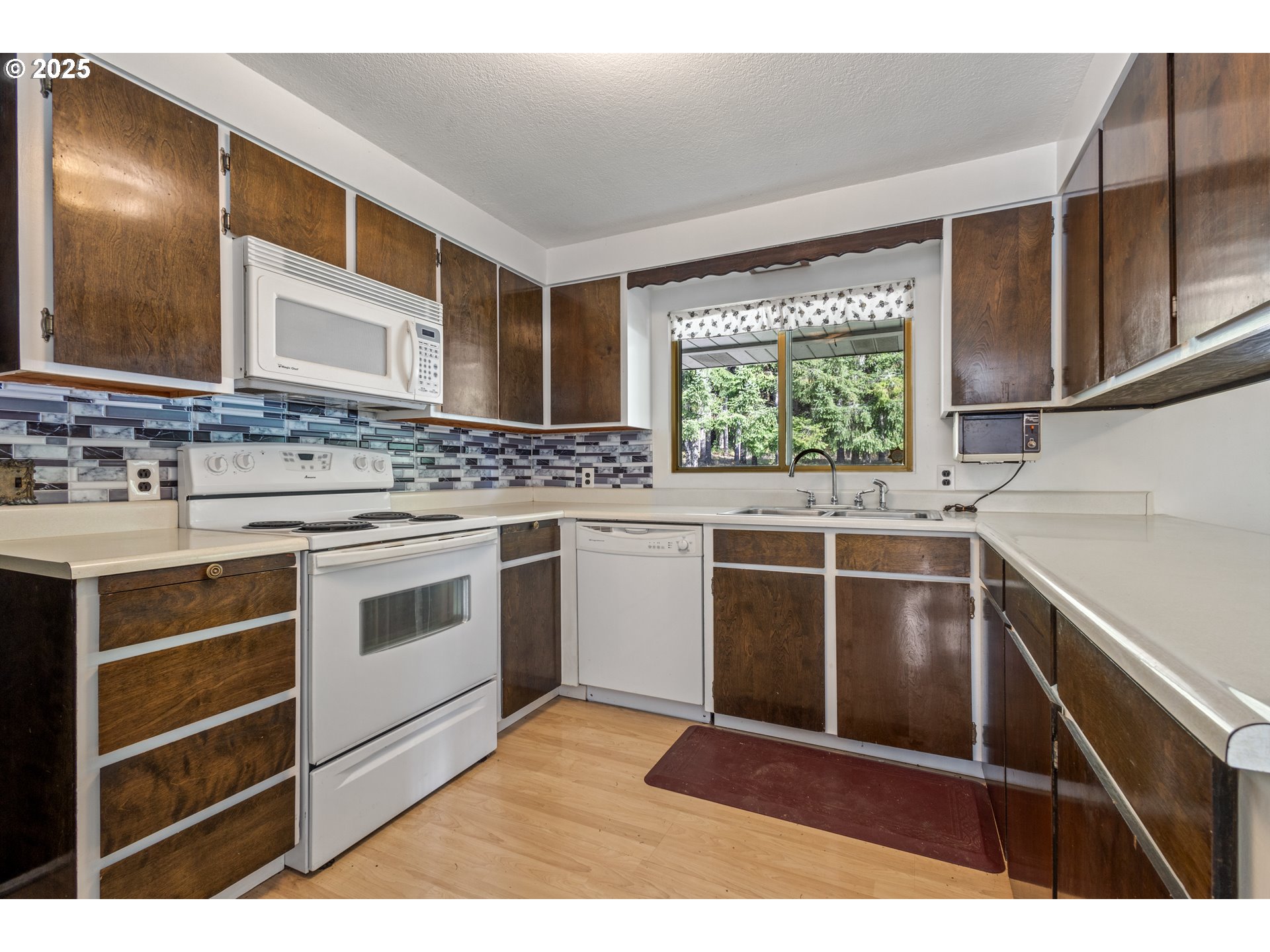 5673 Southwest Old Highway 47 Gaston, OR 97119 - Photo 32 of 33 a kitchen with a stove sink and window