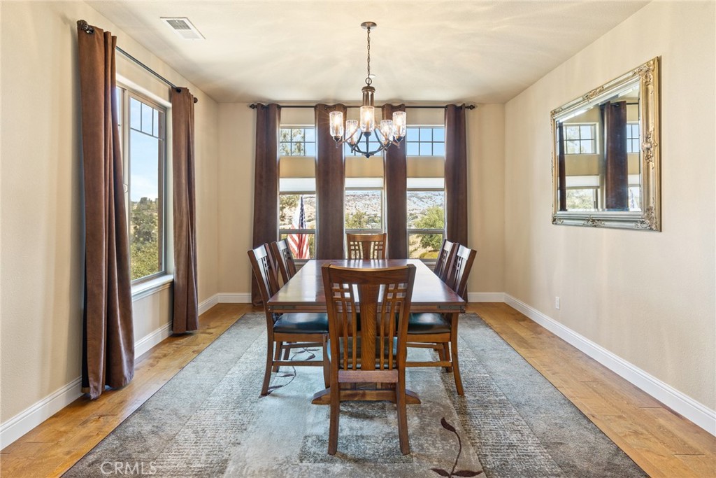 3265 Siena Ridge Loop Chico, CA 95928 - Photo 12 of 19 a dining room with furniture a chandelier and wooden floor