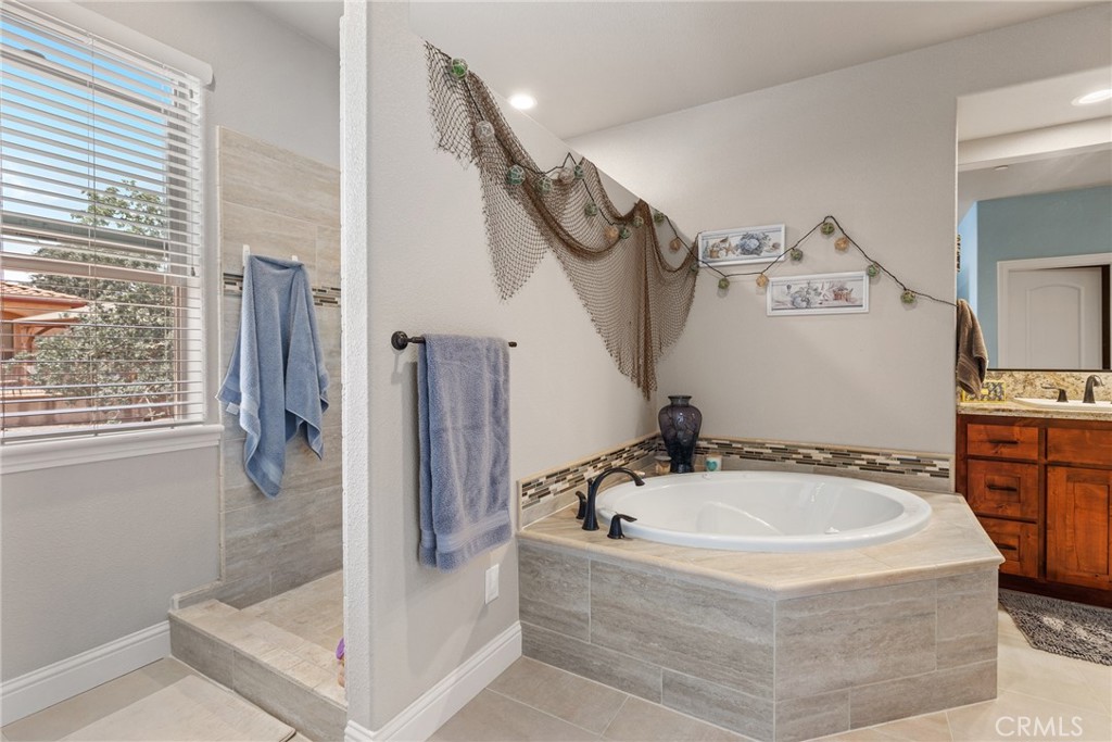 3265 Siena Ridge Loop Chico, CA 95928 - Photo 14 of 19 a bathroom with a tub sink and mirror