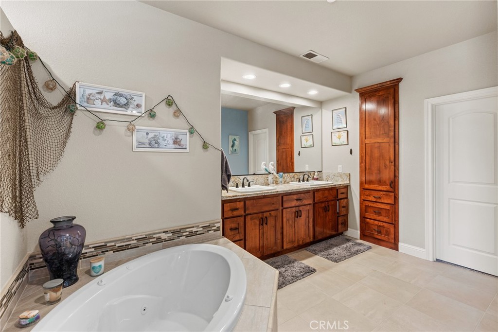 3265 Siena Ridge Loop Chico, CA 95928 - Photo 15 of 19 a bathroom with a tub sink and mirror