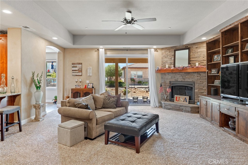 3265 Siena Ridge Loop Chico, CA 95928 - Photo 5 of 19 a living room with furniture a flat screen tv and a fireplace