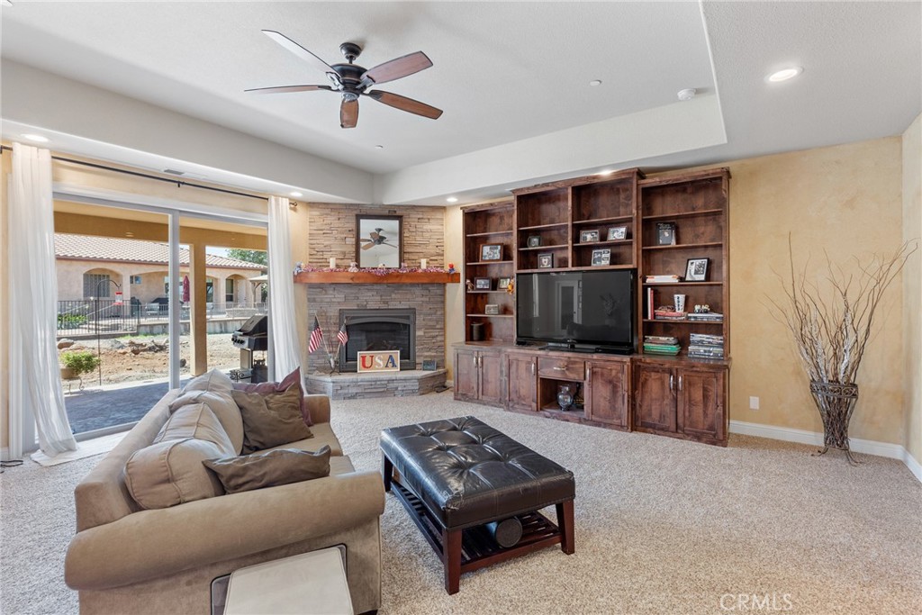 3265 Siena Ridge Loop Chico, CA 95928 - Photo 6 of 19 a living room with furniture a flat screen tv and a fireplace