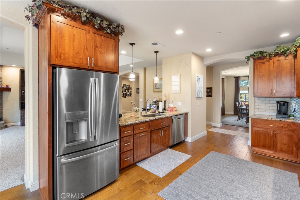 3265 Siena Ridge Loop Chico, CA 95928 - Photo 10 of 19 a kitchen with stainless steel appliances granite countertop a refrigerator a sink and a stove