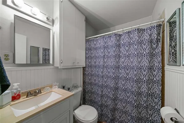 a bathroom with a toilet sink and shower