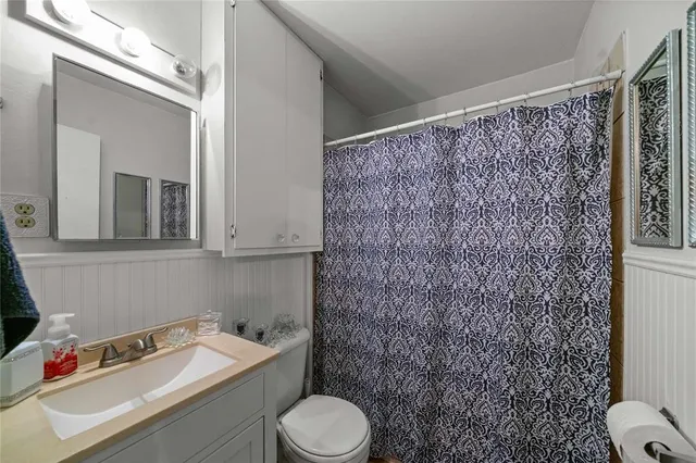a bathroom with a toilet sink and shower