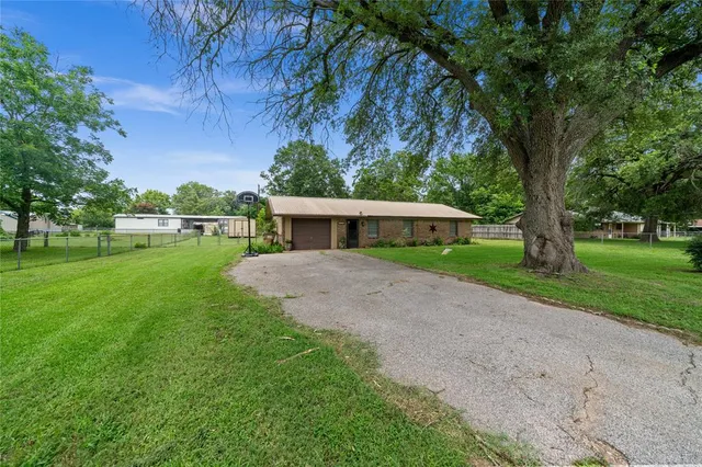 a front view of house with yard and green space