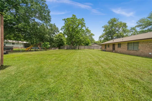 a view of a house with a yard and sitting area