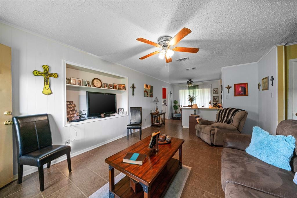 6753 Murphy Street Murchison, TX 75778 - Photo 4 of 24 a living room with furniture and a flat screen tv