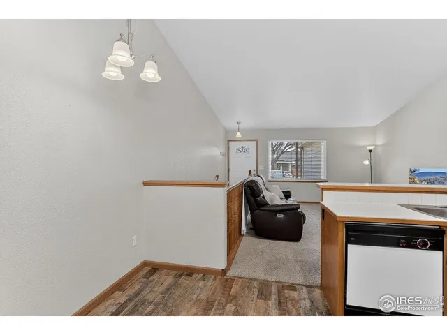 a living room with a table chairs and a chandelier