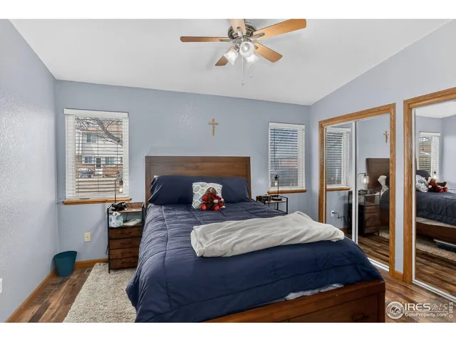 a bedroom with a bed a fireplace and a chandelier