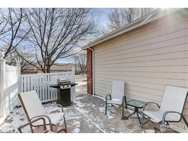 a view of a chairs and table in backyard