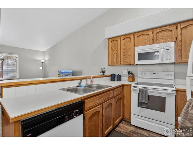 a kitchen with stainless steel appliances granite countertop a sink stove and microwave