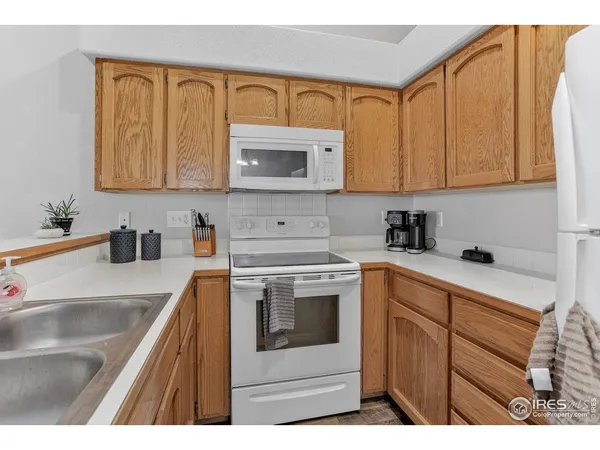 a kitchen with cabinets appliances and a sink