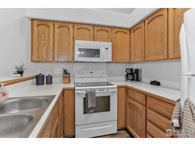 a kitchen with cabinets appliances and a sink