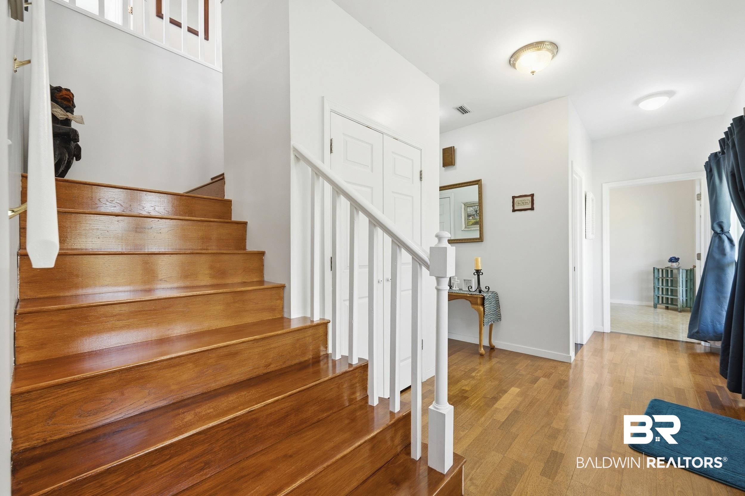 15855 Calvin Richerson Road Bay Minette, AL 36507 - Photo 40 of 83 Hardwood staircase with white spindle railing and brass handrail