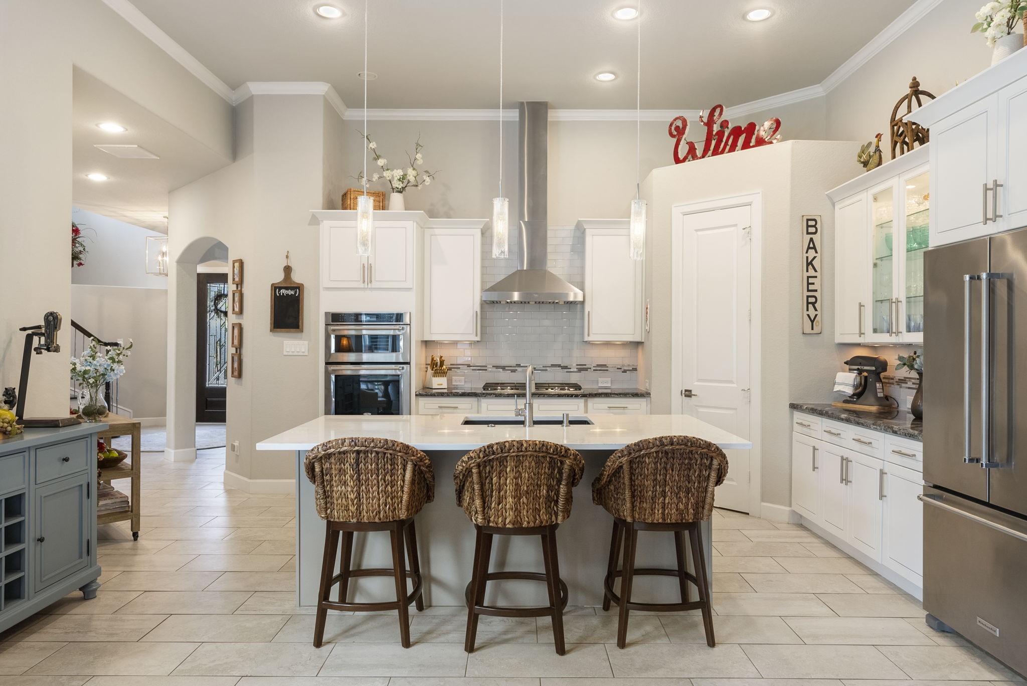 25607 Muirfield Bend Court Spring, TX 77389 - Photo 8 of 30 Chef-inspired kitchen featuring an oversized center island, custom cabinetry, stainless steel appliances, and abundant prep space designed for both everyday living and effortless entertaining.