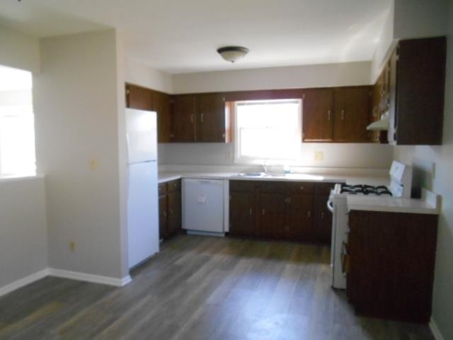 1908 Ridgeland Road Rockford, IL 61108 - Photo 11 of 20 a kitchen with stainless steel appliances granite countertop a sink a stove a refrigerator a window and wooden floor
