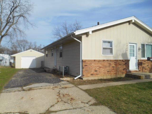 1908 Ridgeland Road Rockford, IL 61108 - Photo 3 of 20 a front view of a house with a yard