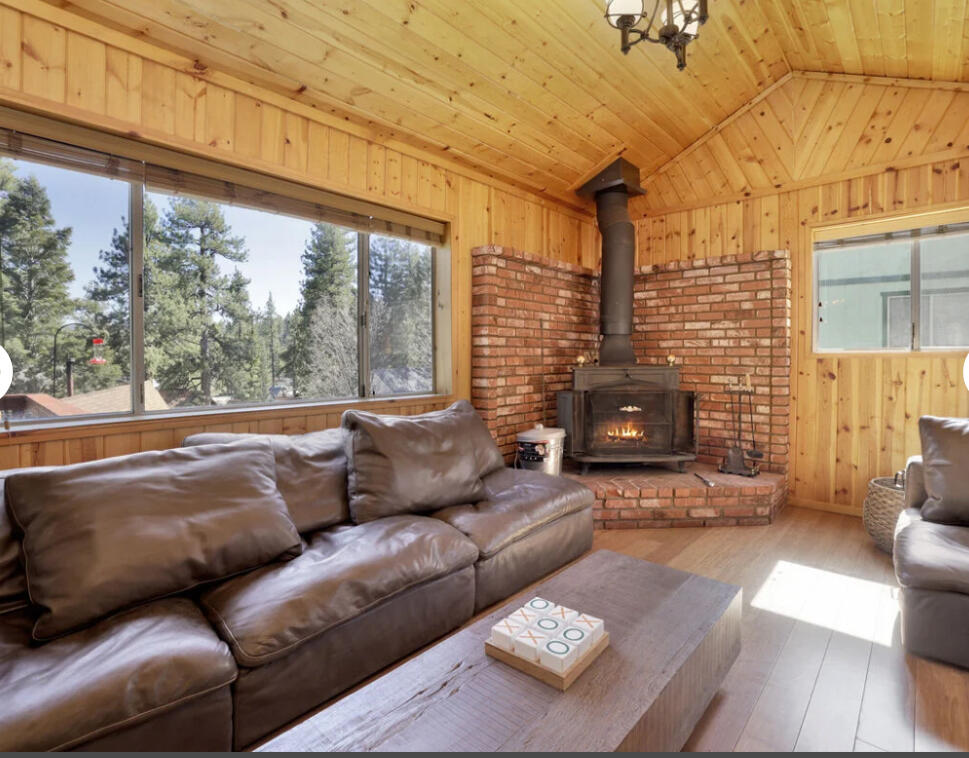 39187 Arapahoe Road Fawnskin, CA 92333 - Photo 18 of 18 a living room with furniture and a fireplace