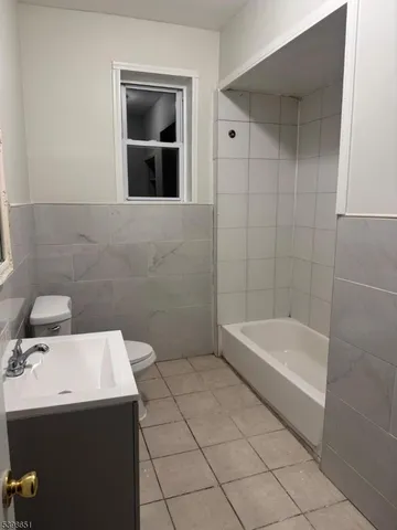a bathroom with a sink a toilet and bathtub