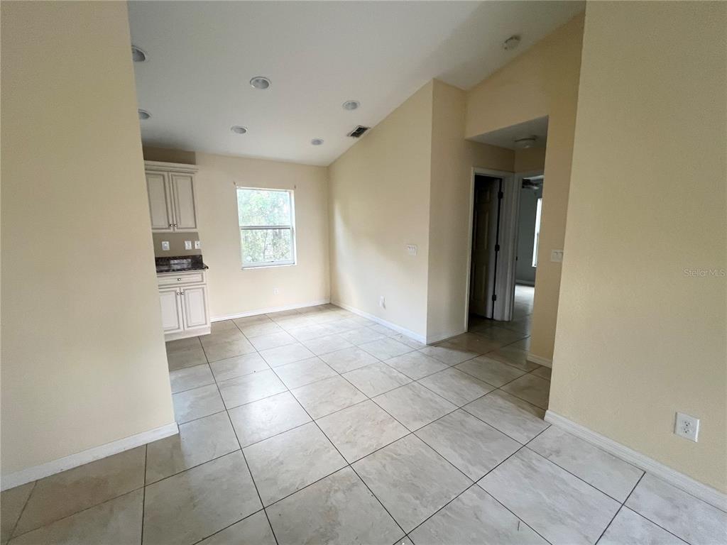3281 Easy Street Port Charlotte, FL 33952 - Photo 3 of 8 wooden floor in an empty room and a window