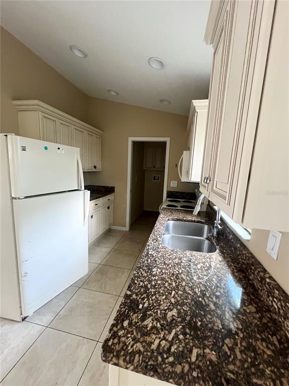 3281 Easy Street Port Charlotte, FL 33952 - Photo 4 of 8 a kitchen with a refrigerator and a stove