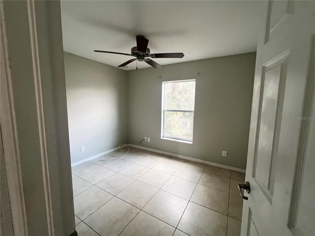 3281 Easy Street Port Charlotte, FL 33952 - Photo 5 of 8 a view of an empty room and a window