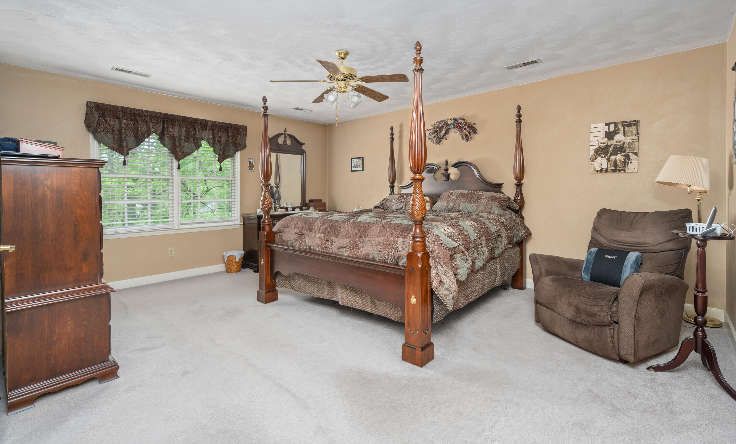 480 Downing Street Roanoke, VA 24019 - Photo 13 of 29 a spacious bedroom with a bed and a couch