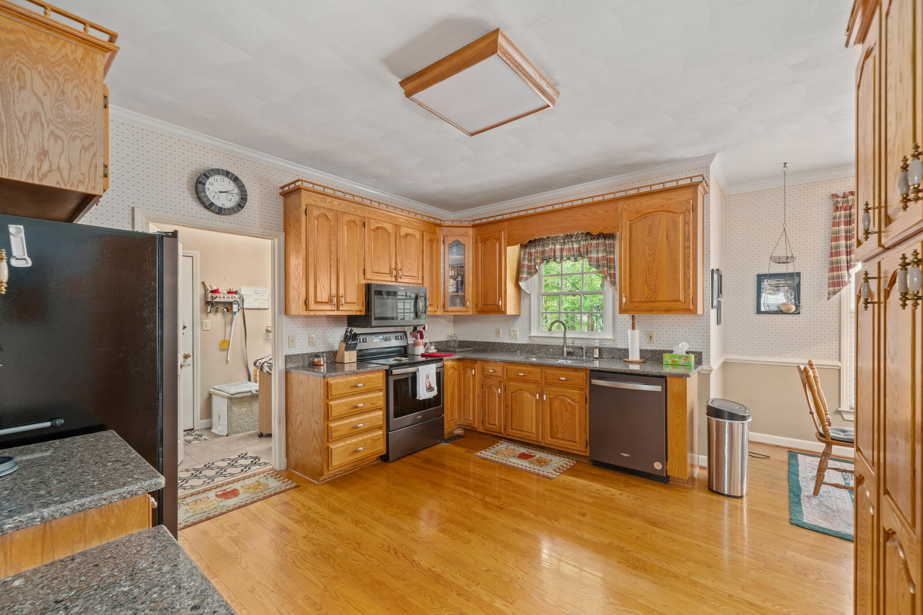 480 Downing Street Roanoke, VA 24019 - Photo 6 of 29 a large kitchen with stainless steel appliances granite countertop a stove refrigerator and cabinets