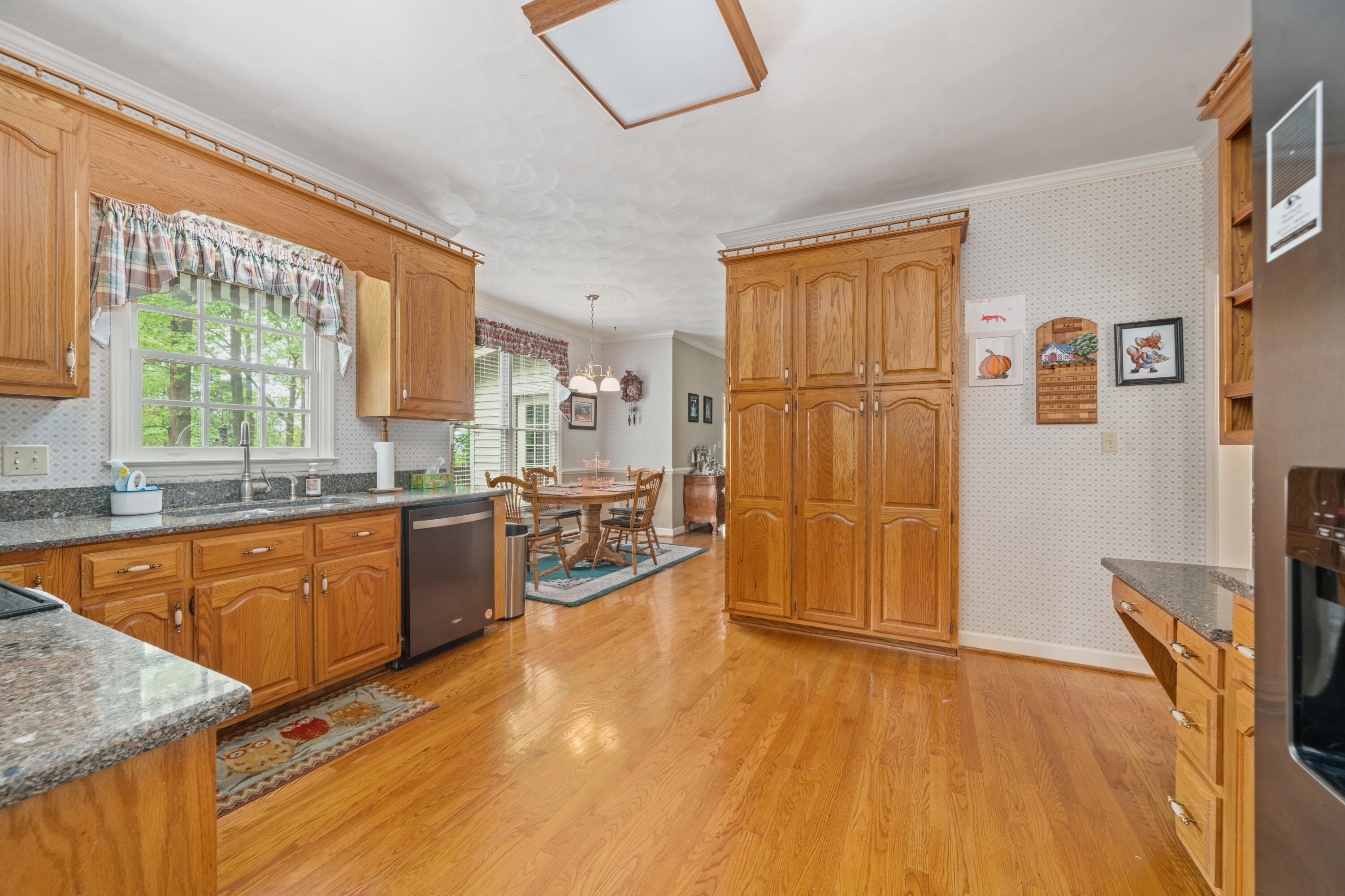 480 Downing Street Roanoke, VA 24019 - Photo 8 of 29 a large kitchen with a wooden floor and a large window
