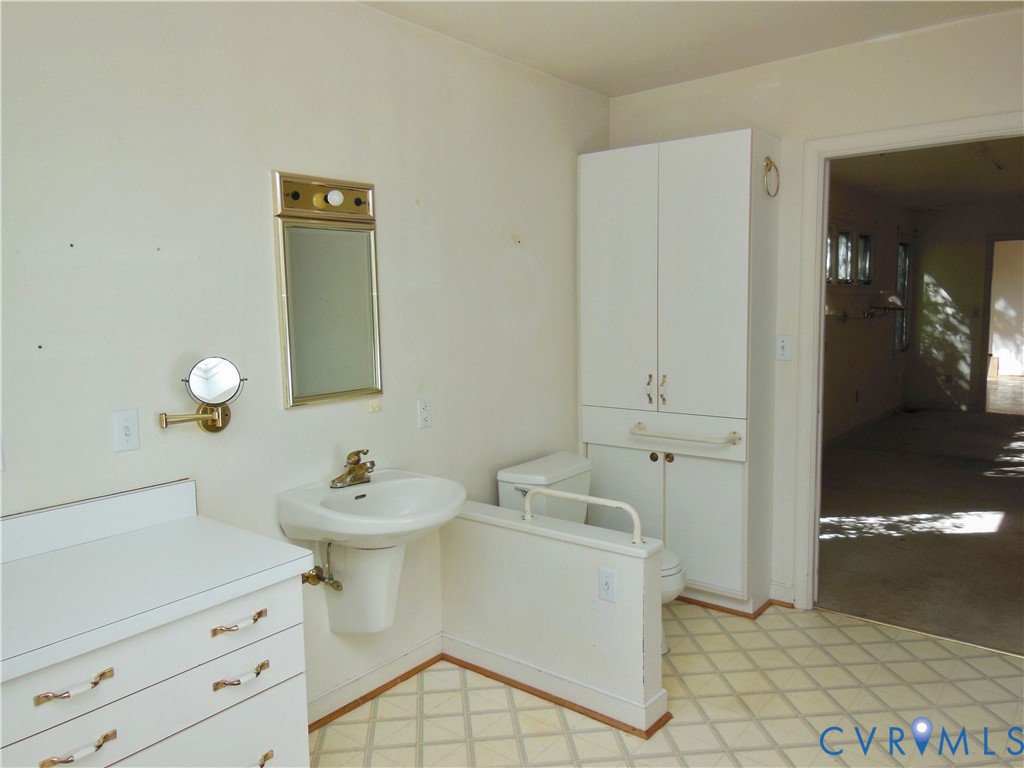 8218 Overbury Road Richmond, VA 23227 - Photo 15 of 37 a bathroom with a sink toilet and shower