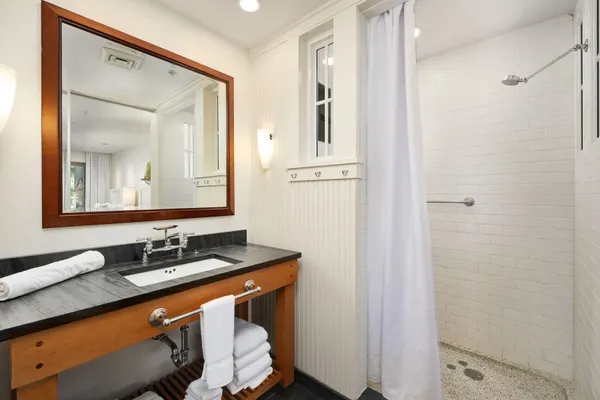 a bathroom with a sink a toilet and shower