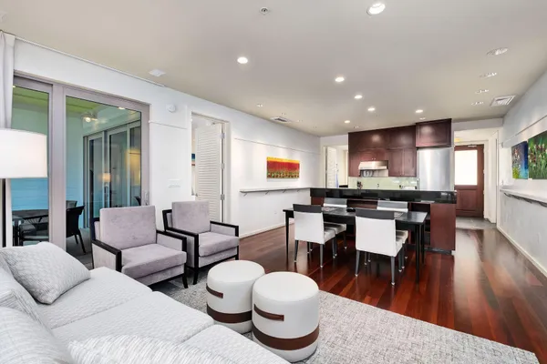 a living room with lots of furniture and kitchen view