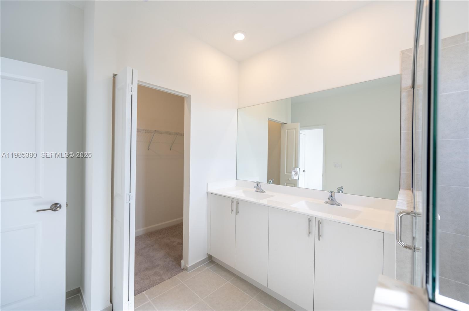 13380 Southwest 287th Terrace Homestead, FL 33033 - Photo 14 of 21 a bathroom with a double vanity sink and mirror