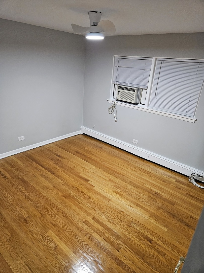 2348 West 111th Street, Unit 2 Chicago, IL 60643 - Photo 4 of 23 wooden floor in an empty room
