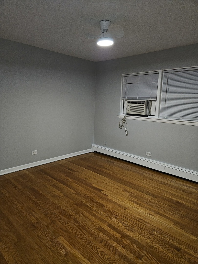 2348 West 111th Street, Unit 2 Chicago, IL 60643 - Photo 5 of 23 a view of empty room with wooden floor and fan