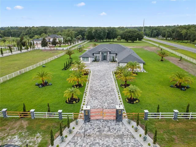 an aerial view of a golf course with a lake view