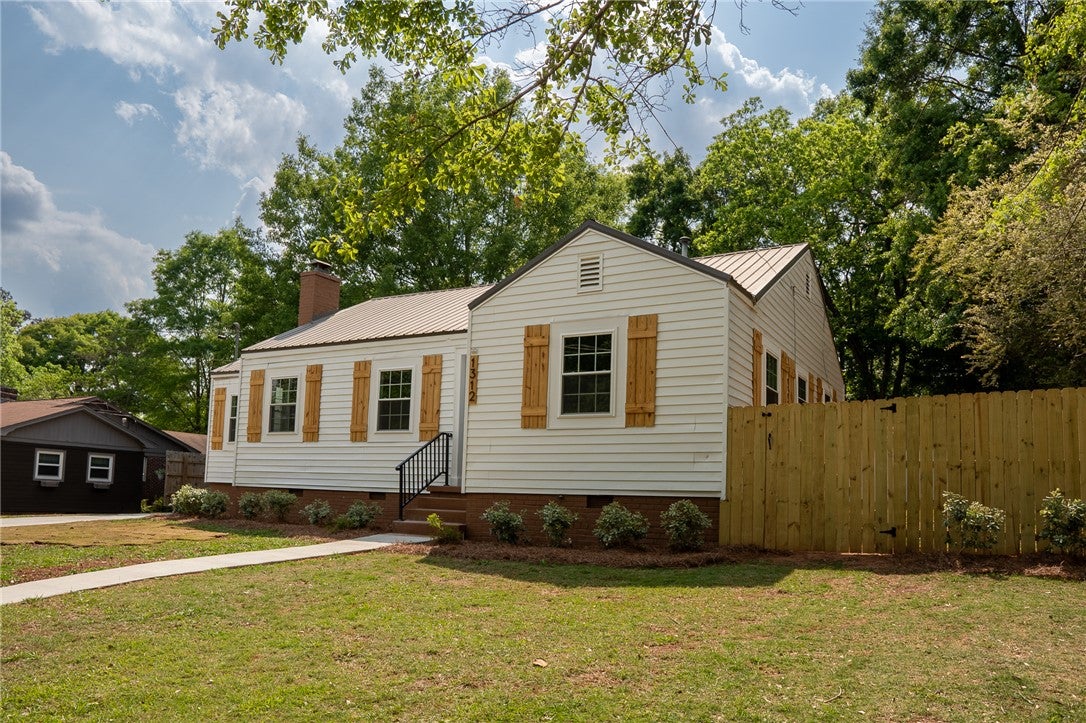 1312 Rocky Brook Road Opelika, AL 36801 - Photo 43 of 45 This charming home offers classic appeal with a durable metal roof and a private fenced yard.