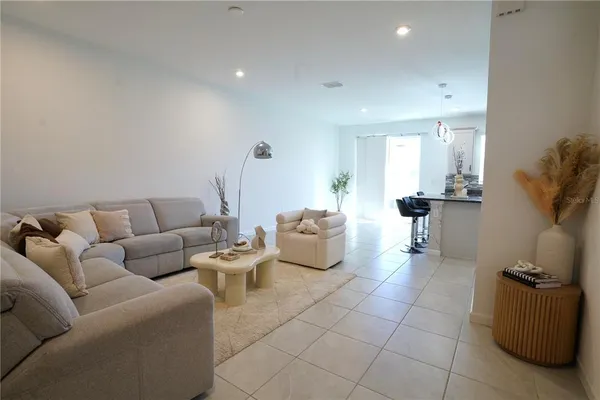 a living room with furniture and a ceiling fan