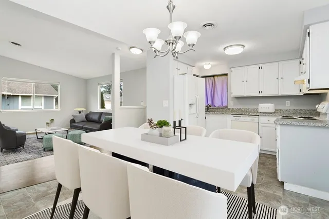 a kitchen with kitchen island granite countertop a sink a center island cabinets and furniture